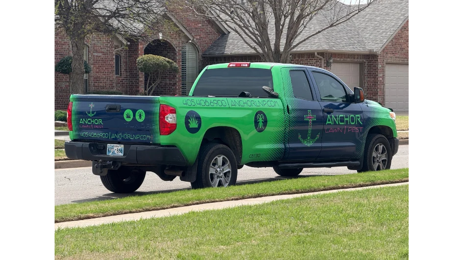 Branded lawn and pest truck on a residential service route