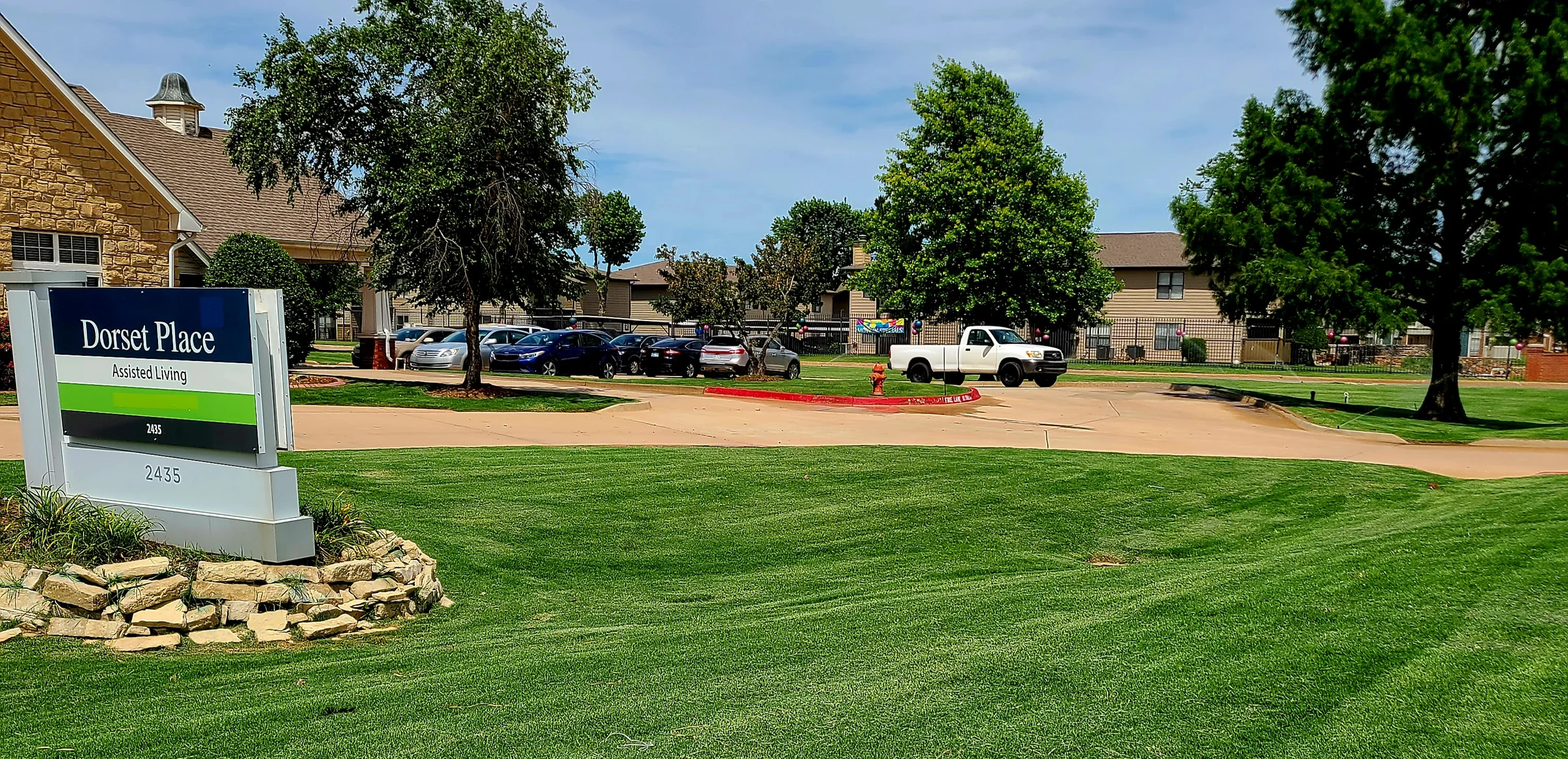 Wide view of maintained turf surrounding a multi-building property